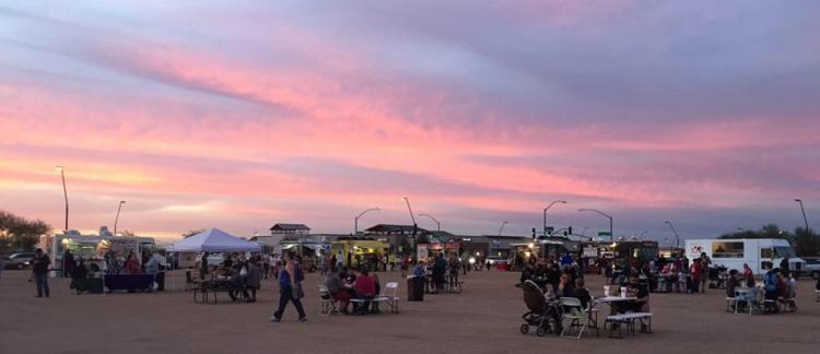 people gather for the Queen Creek Food Truck Festival at sunset